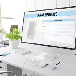 Dental insurance form displayed on large computer monitor