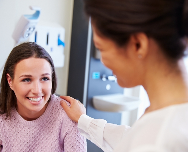 Oral surgery team member talking to patient