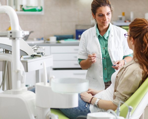 a patient speaking to a dentist about broken front tooth