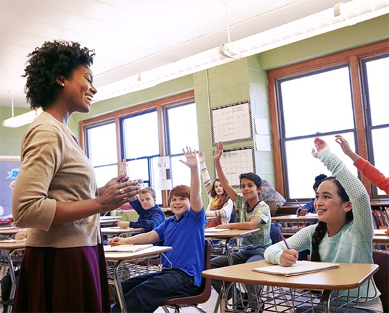 Students raising hands in Coppell classroom