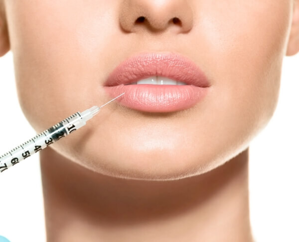 Patient receiving lip enhancement injections