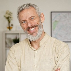 mature man smiling after getting dental implants in Coppell 