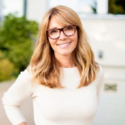 mature woman smiling after getting dental implants in Coppell 