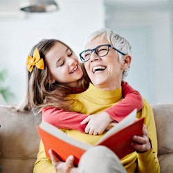 mature woman smiling with young girl after dental implants in Coppell