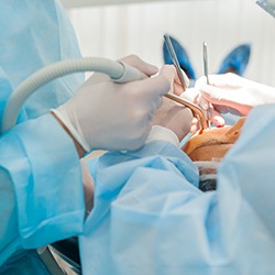 Dentists performing dental implant surgery