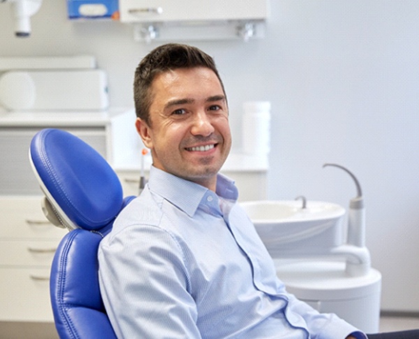 Man in collared shirt smiling