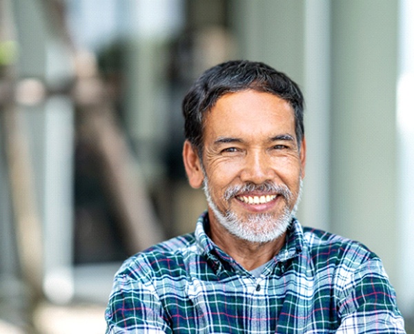 Man smiling with dental implants in Coppell, TX