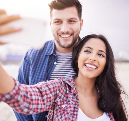 Man and woman taking selfie outdoors