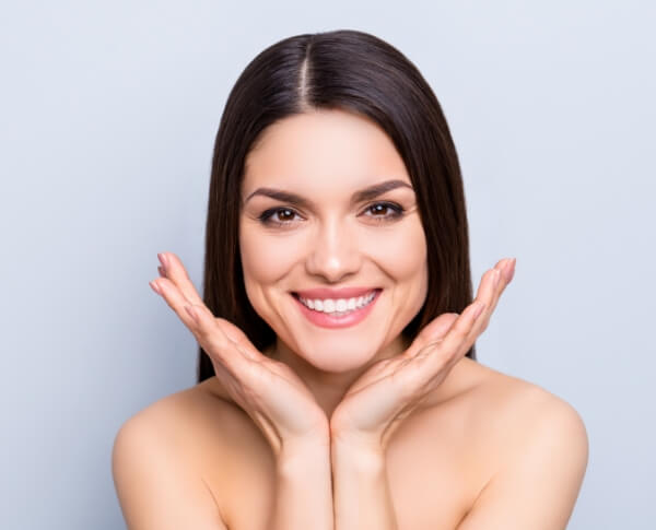 Woman framing her face with her hands after Juvederm treatment