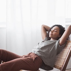 a woman relaxing following dental implant post-op instructions in Coppell