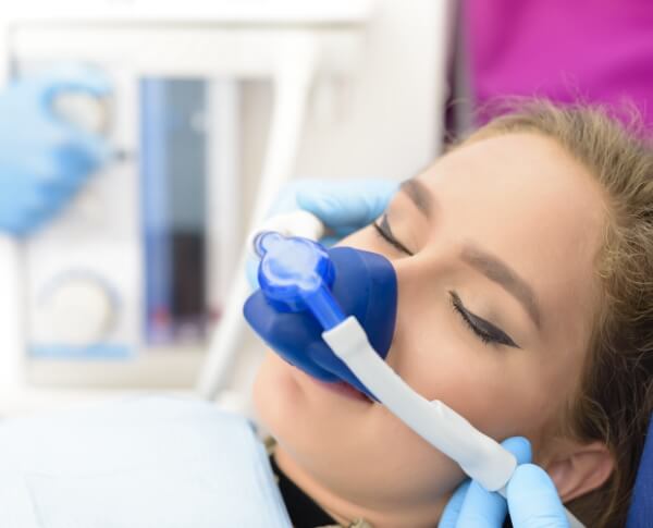 Patient with nitrous oxide sedation dentistry mask in place