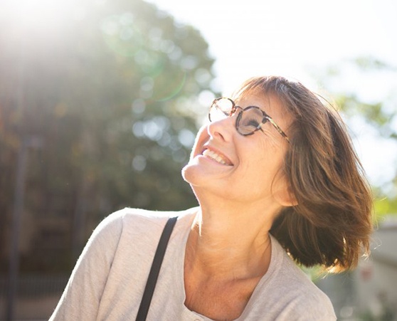 Lady smiles while reviewing insurance coverage