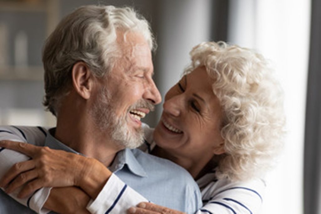 Older couple with dental implants.