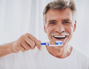 senior man brushing his teeth