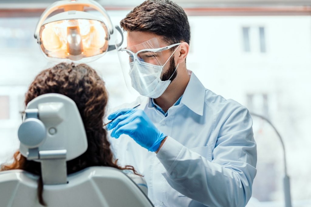 person at dentist undergoing tooth extraction
