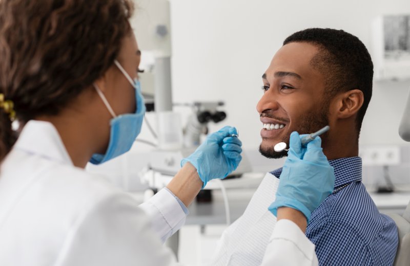 Patient smiling with their new dental implants