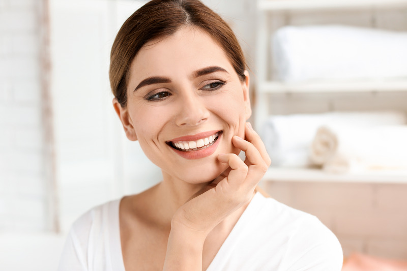 Patient smiling as they prepare for dermal fillers